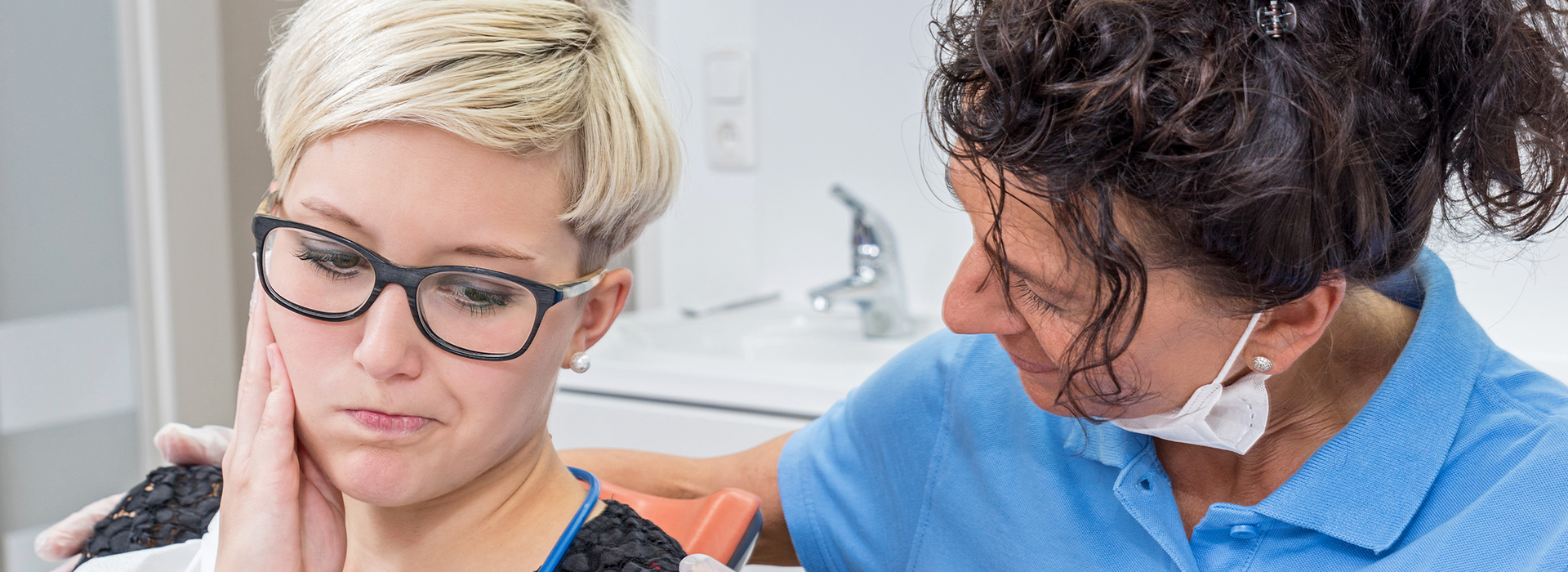 The image shows a dental hygiene scene with a patient and a dental professional, likely in a dental office setting.